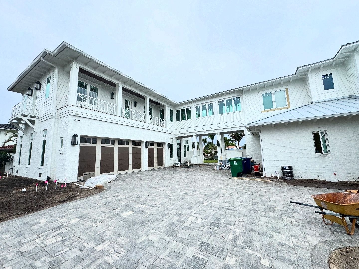 Large white coastal estate under construction with clean windows