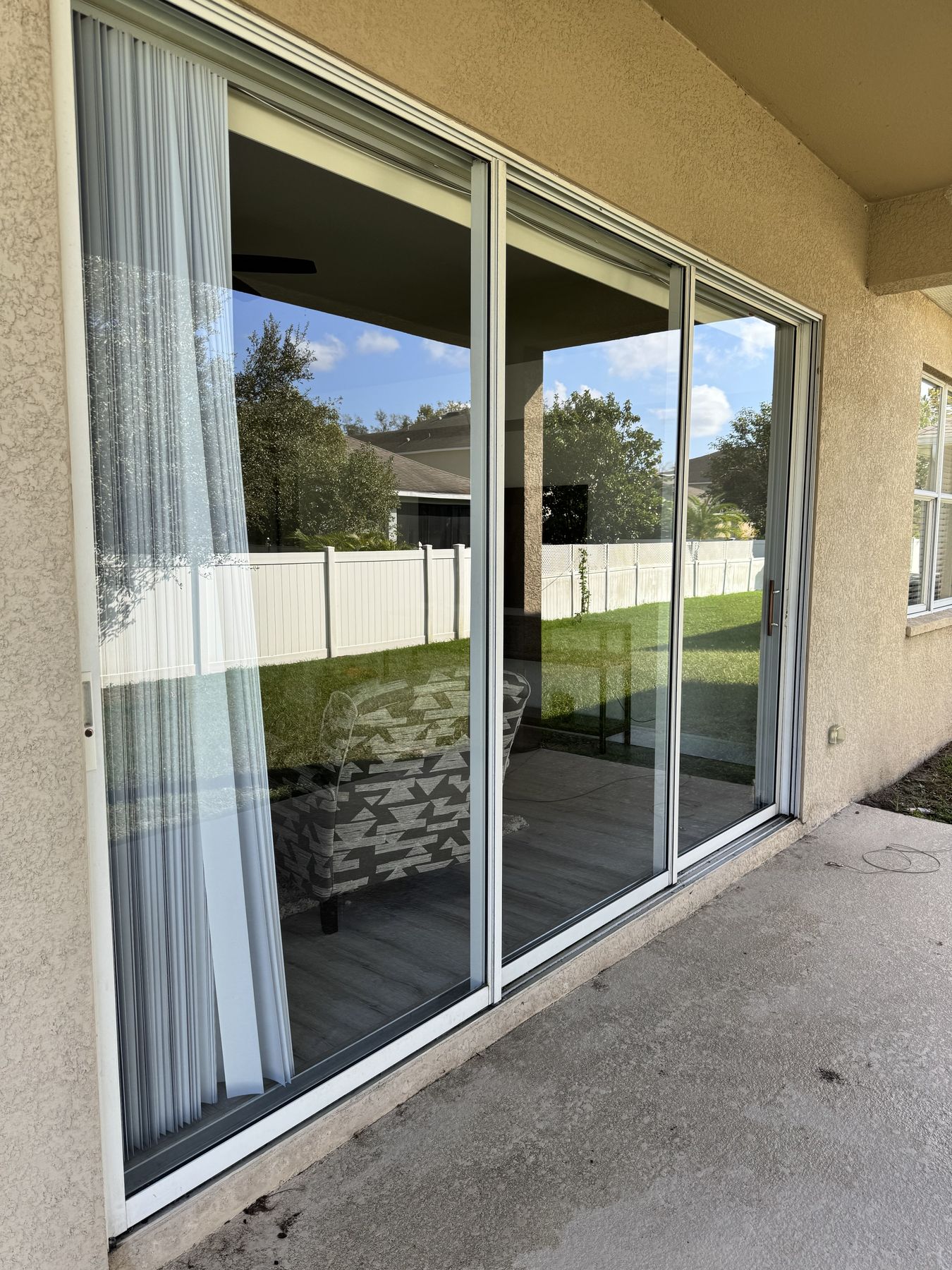 Patio sliding glass doors opening onto a backyard