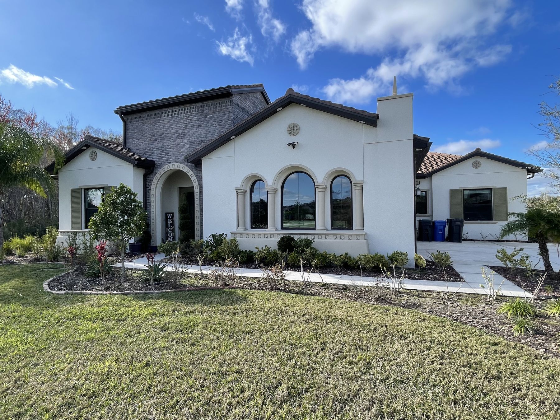 Spanish-style home with clean arched front windows